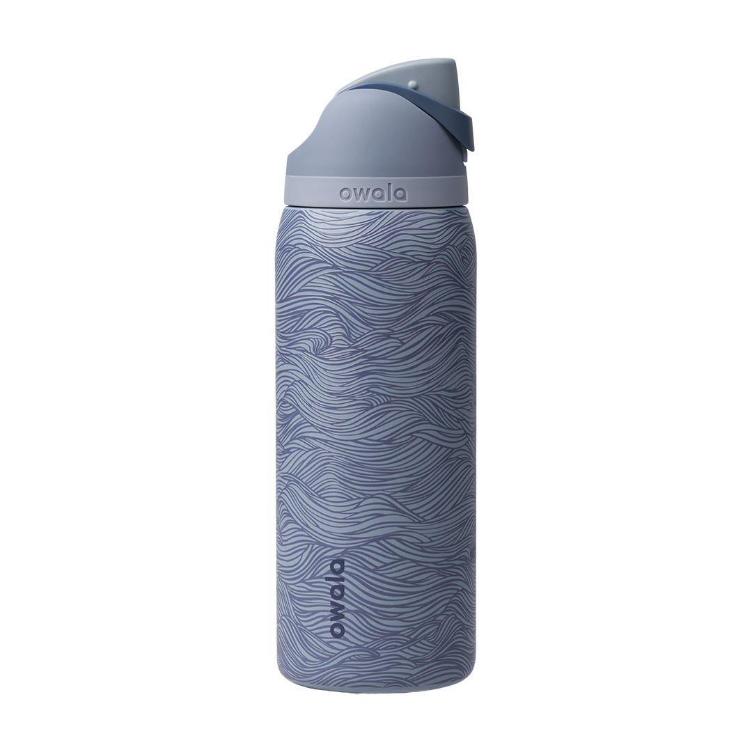 Owala FreeSip 32oz, slate blue body with embossed wave texture, lighter blue-gray lid, slate flip cap, and darker blue carry loop