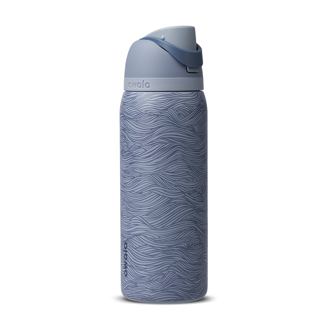 Owala FreeSip 32oz, slate blue body with embossed wave texture, lighter blue-gray lid, slate flip cap, and darker blue carry loop