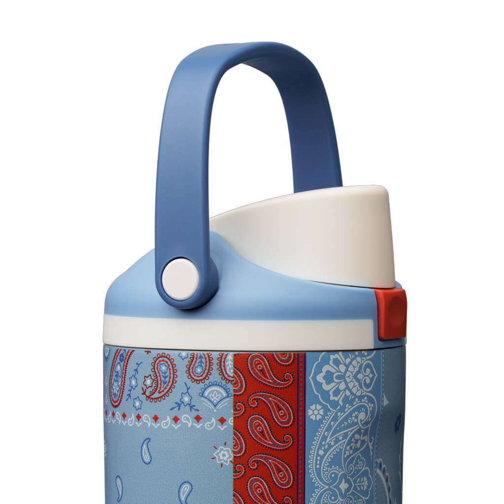 Owala FreeSip Sway 30oz, red, white, and blue paisley bandana patchwork body with light blue lid, white flip cap, and darker blue carry loop raised
