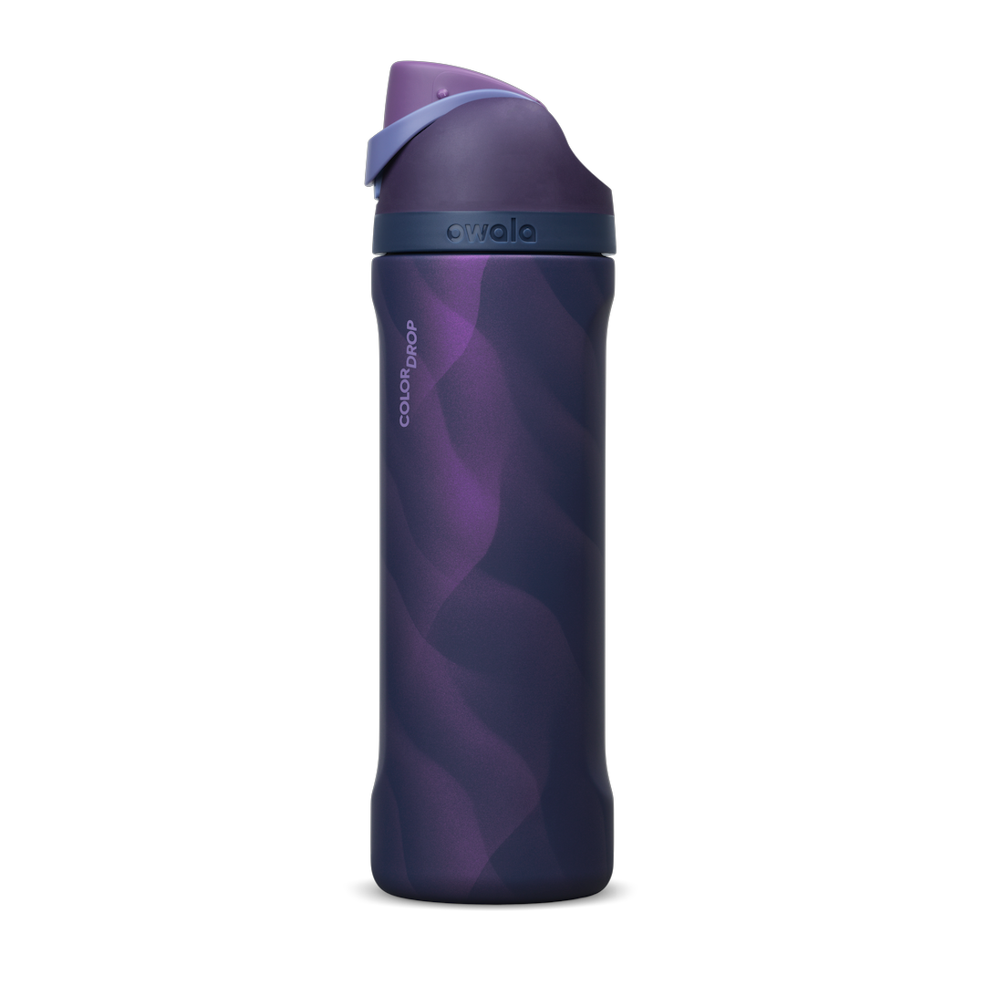 Owala FreeSip 24oz in Arctic Storm, deep purple insulated stainless steel bottle with wavy lavender pattern, navy lid with periwinkle carry loop and deep purple flip cap