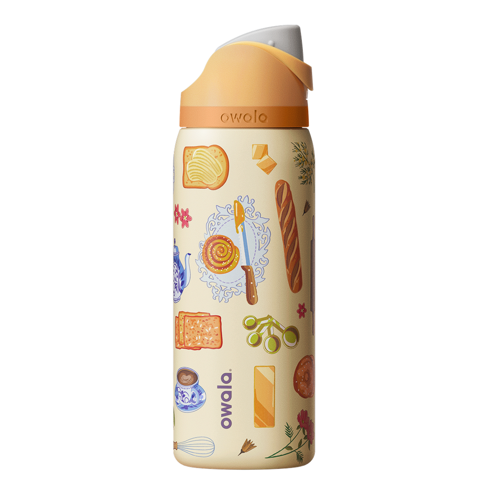 Owala FreeSip 32oz in Brunch Bunch, cream body with brunch-themed illustrations of bread, butter, pastries, teacups, and flowers, peach flip cap with cream carry loop