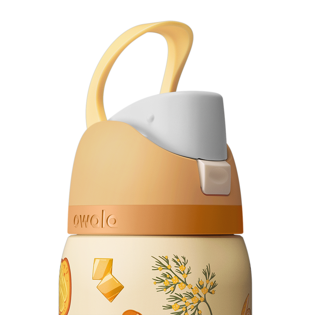 Owala FreeSip 32oz in Brunch Bunch, close-up of the peach flip cap with cream carry loop raised, push-button release visible