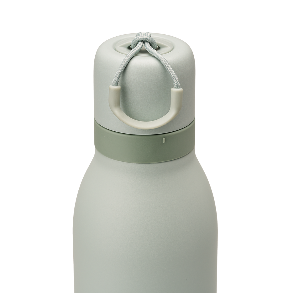 Owala FreeSip Twist 24oz in Summer Paradise, lid detail showing sage green twist cap in place with off-white carry string and carry string grip, darker sage accent band where cap meets the body